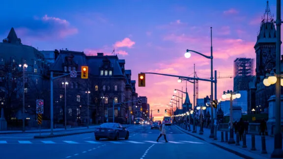Sunset view of Wellington street, with Parliament buildings to the right.