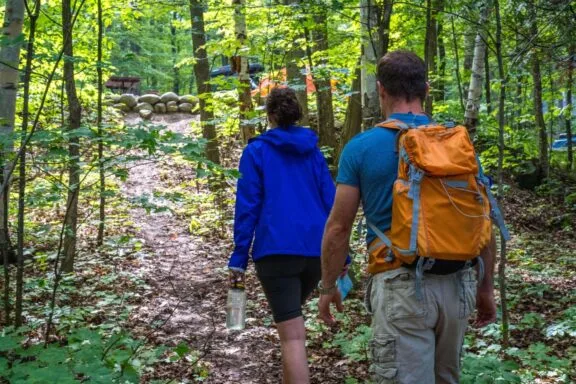 2 people walking on a trail