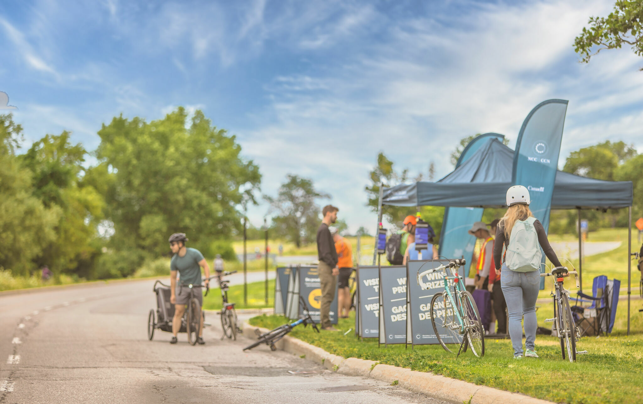 An NCC tent with cyclists receiving safety information