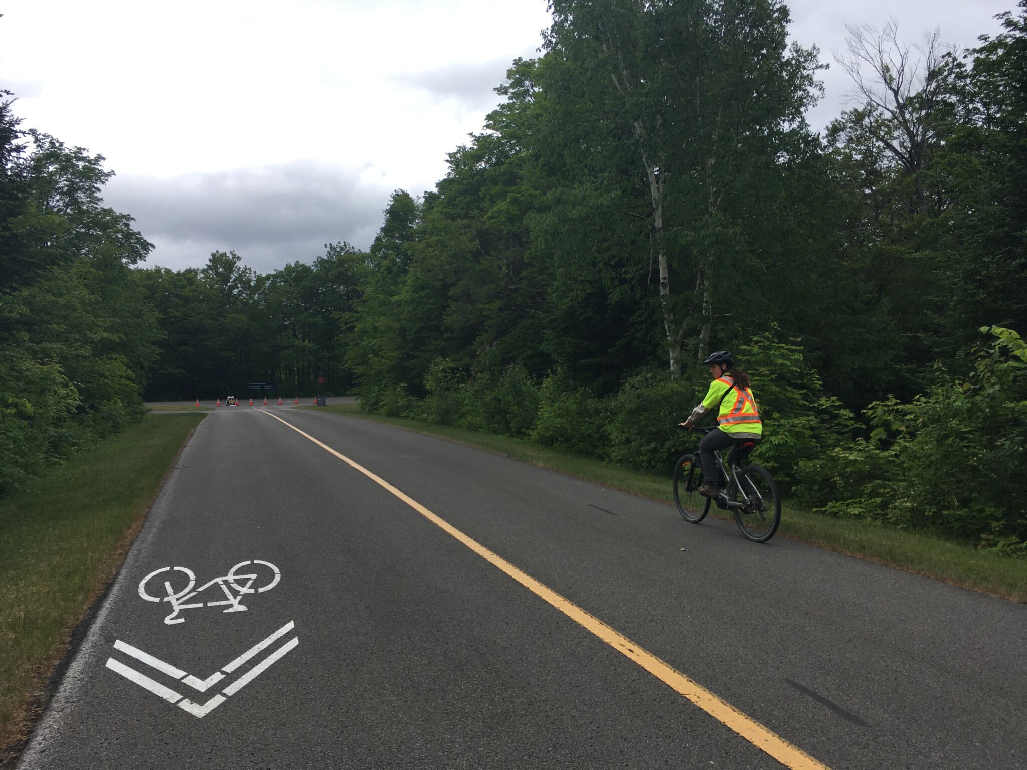 Lilli riding a bike on a road survey outing.