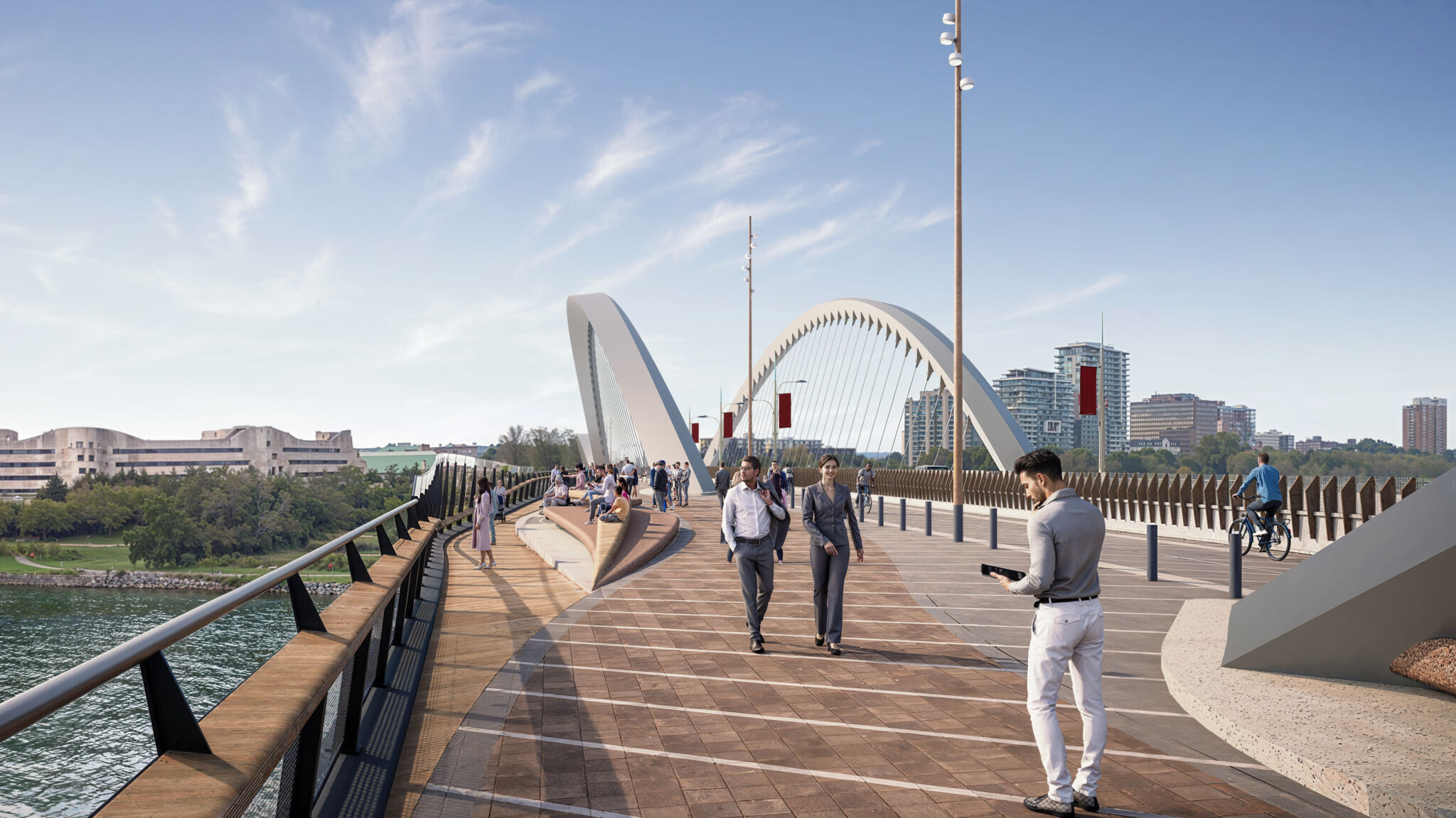 The lookout space is on the left, the walkway is in the centre and the cycleway is on the right. The lookout space has a wooden surface with railings overlooking the river. The walkway in the centre has a brick-like pattern and is used by pedestrians. The cycleway on the right has a smoother surface for cyclists. People are walking and cycling, respectively, on these paths. Buildings and bridge arches are visible in the background.