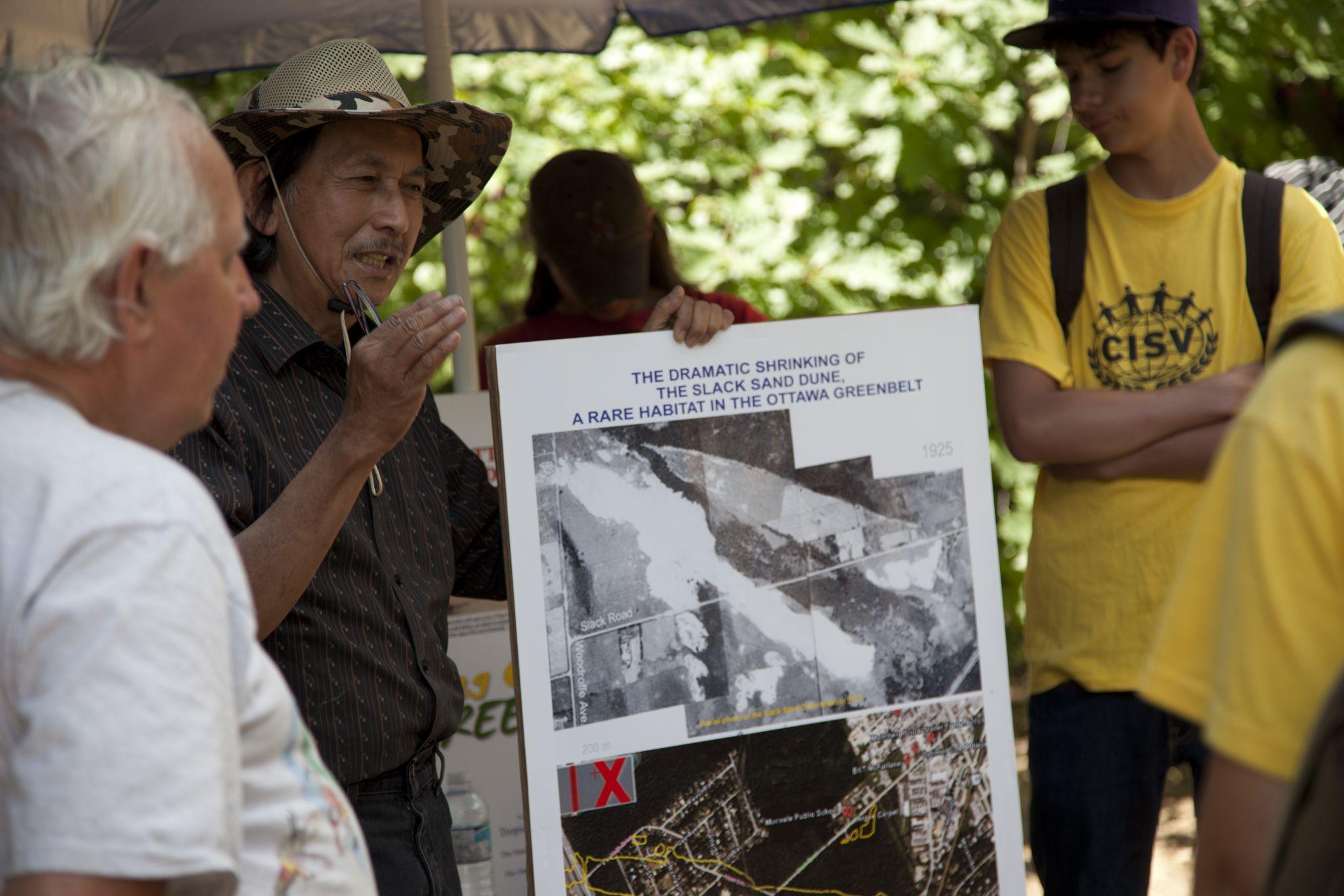 Volunteers holding before and after pictures.