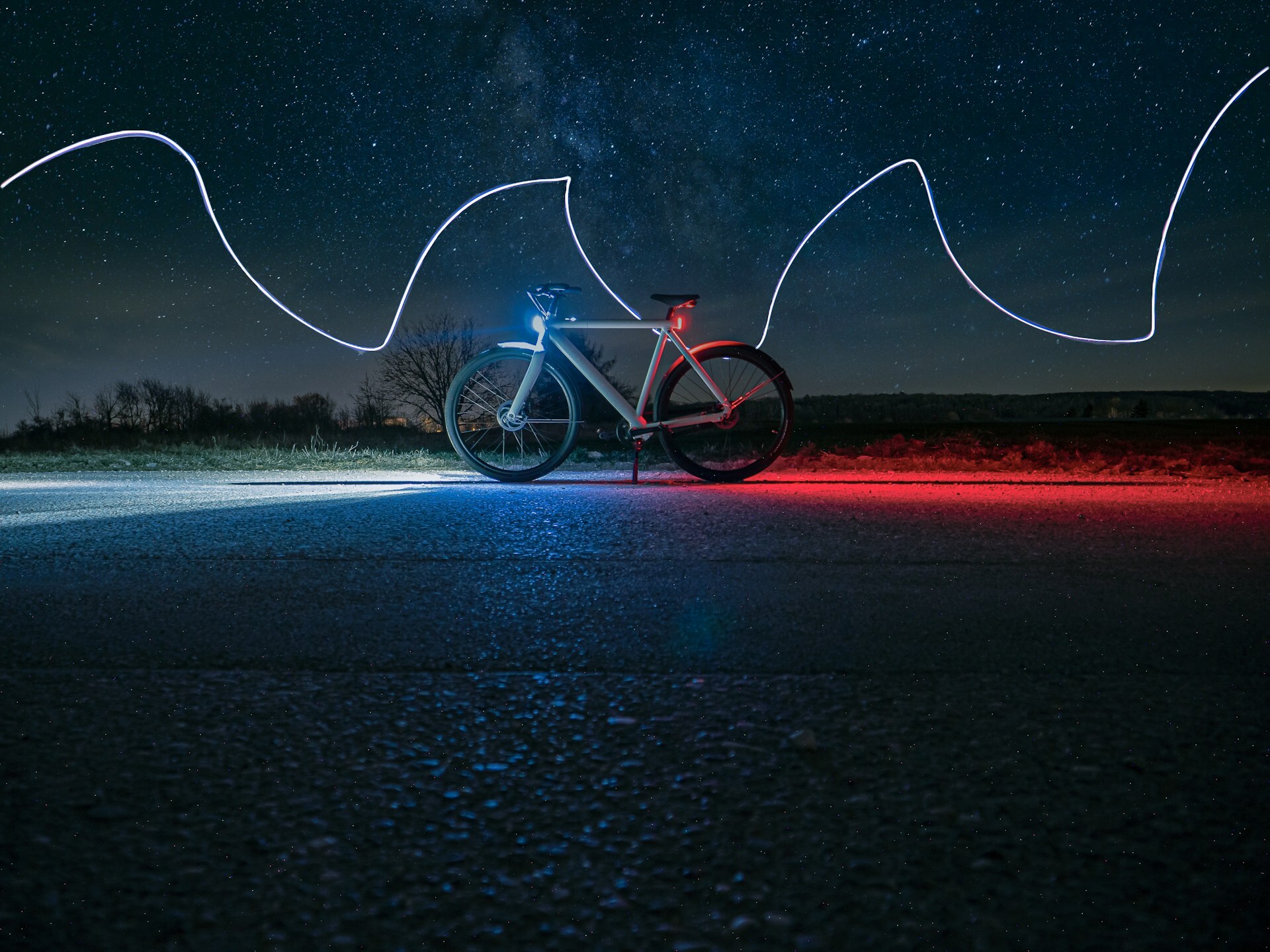 Graphic design of an illuminated bike at night